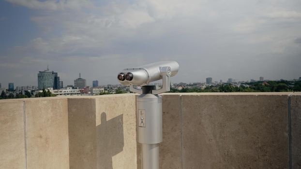 Close up of telescope on skyscraper rooftop