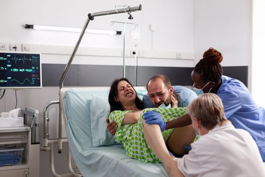 Pregnant person in labor with contractions giving birth