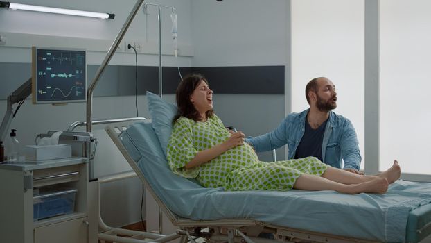 Caucasian woman with pregnancy having painful contractions