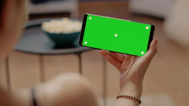 Close up of horizontal smartphone with green screen