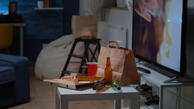 Close up of table with food and booze leftover on misery table