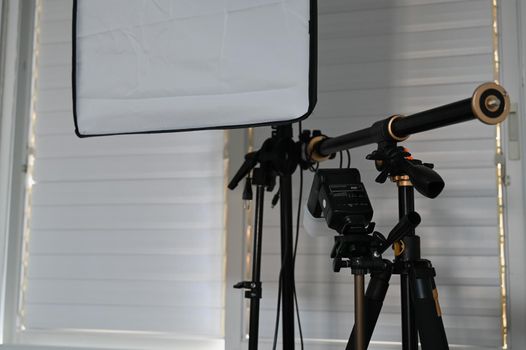 equipment for a home photo studio is located near the window