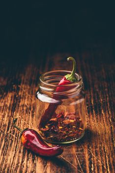 Two dried red chili peppers in jar