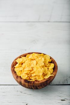 Corn flakes in a wooden bowl
