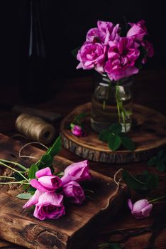 Pink garden roses on wooden table