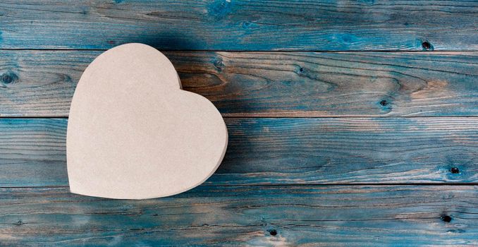 Valentines day background with lovely heart shaped giftbox on faded blue wood