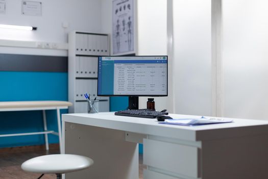 Empty desk with medical documents and clinical appointment on computer