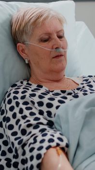 Woman with sickness waiting for medical treatment in bed