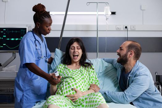 Young woman in labor screaming from contractions