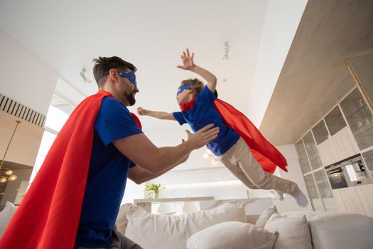 Father and son play superhero