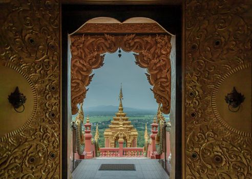 Forest landscape under cloudy blue sky from gate of Wat Phra That Doi Phra Chan in Lampang. 