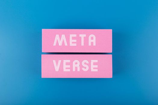 Metaverse modern minimal concept with written text meta verse on pink rectangles against dark blue background 