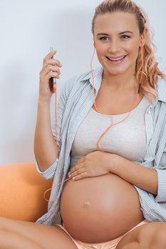 Pregnant Woman Listens Music