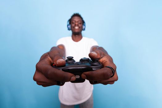 Person showing controller to play video games