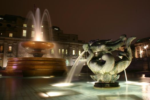 Fountains in Trafalgar Square London at night