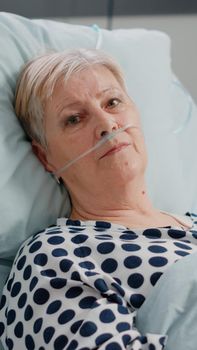 Portrait of senior patient with illness looking at camera