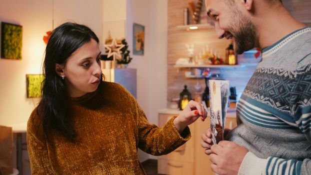 Man and woman preparing christmas card for holiday festivity