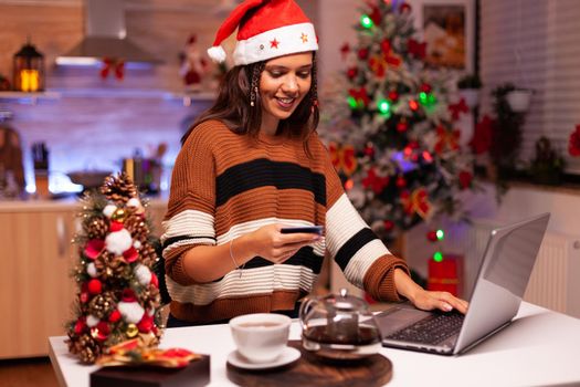 Modern woman paying for gifts with credit card