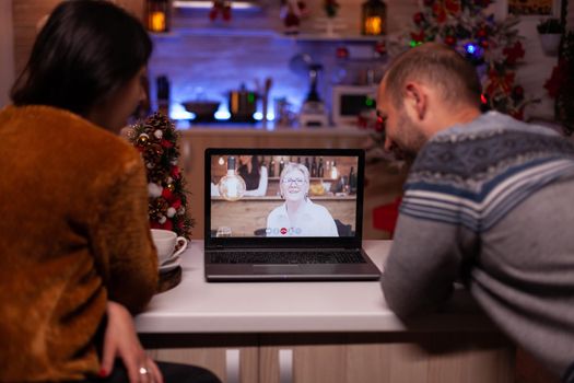 Happy family discussing with remote grandparent during online videocall