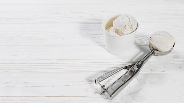 scoop with ice cream ball near cup. High quality photo