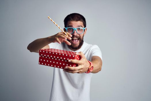 Cheerful man with gift in glasses holiday lifestyle fashion surprise. High quality photo