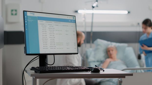 Close up of computer with information files for healthcare system. Desk with medical equipment and monitor with checkup document on screen in hospital ward. Modern display for diagnosis