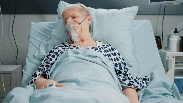 Retired woman with oxygen tube against respiratory problem