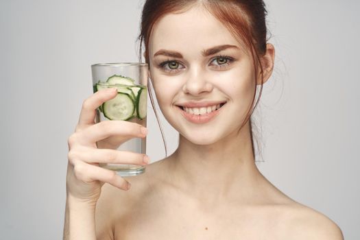 woman with bare shoulders cucumber health drink Fresh. High quality photo