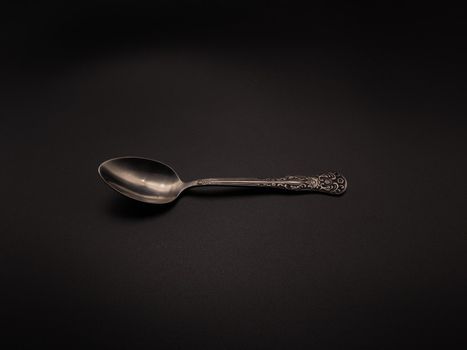 Clean teaspoon on a dark background. Object shooting
