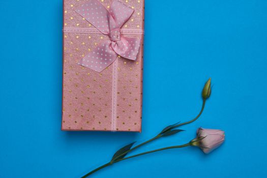 gift box flowers celebration birthday blue background. High quality photo