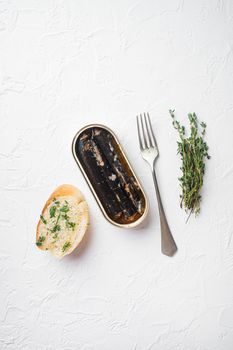 Canned seafood preserved in oil, on white stone table background, top view flat lay, with copy space for text