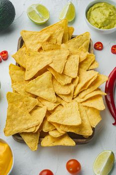 Nachos and guacamole and cheese sauce, on white background