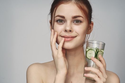 woman with cucumber drink health vitamins close-up