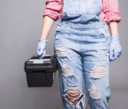 woman overall holding tool box. High quality photo