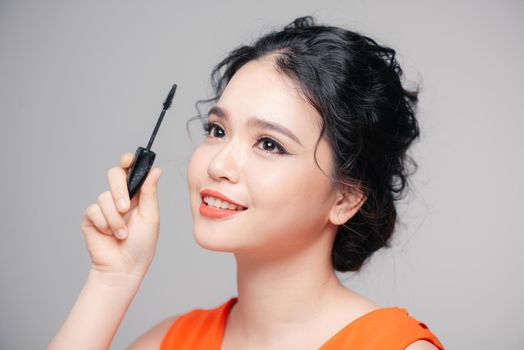 Applying cosmetic make up eyelash Extensions. Asian eye make up cosmetics