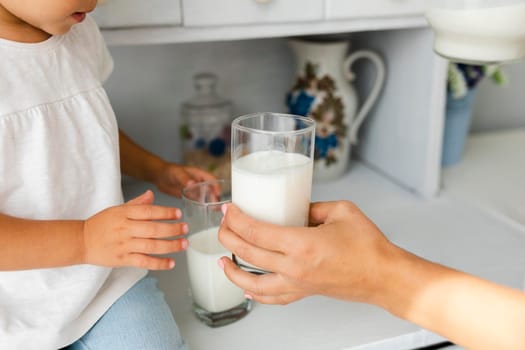 mother hand offering glass milk. High quality photo