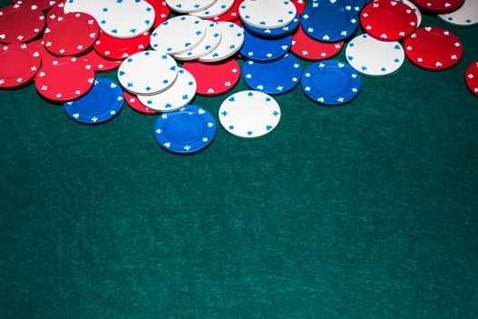 white blue red casino chips green background. High quality photo