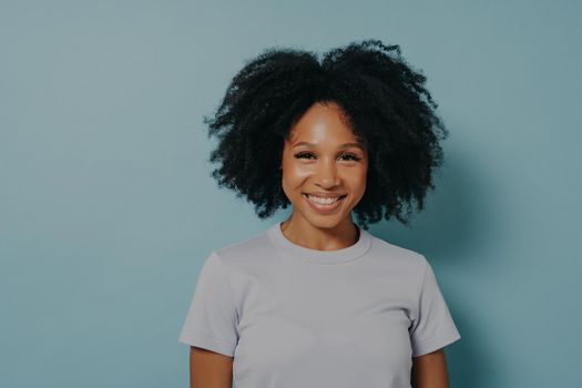 Beautiful smiling african american woman with curly black hair and beaming smile
