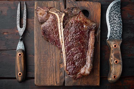 Grilled t bone steak, on wooden serving board, top view flat lay