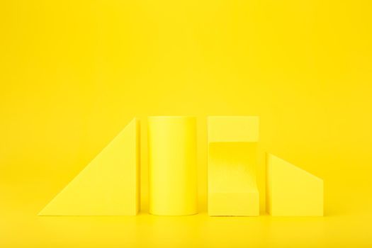 Abstract futuristic background in monochromatic yellow colors with copy space. Different geometric figures in a row