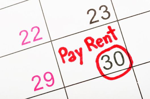 Pay rent is written on calendar.