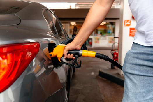 Man fill diesel tank of car in gas station