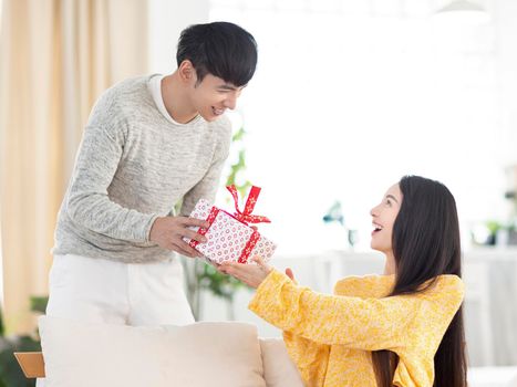 Man gives woman a gift to celebrating holiday