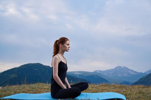 sportive woman workout meditation in the mountains outdoors