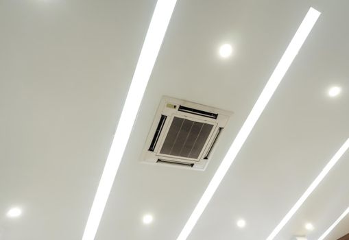 Lighting and ceiling mounted air conditioner on the modern ceiling
