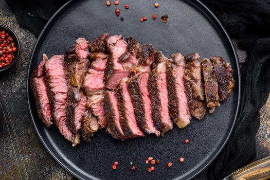 Juicy steak medium rare beef, rib eye cut, on plate, top view flat lay