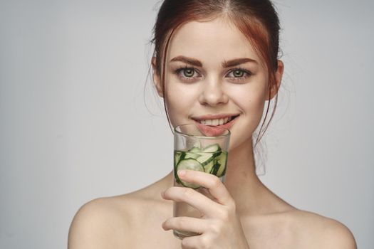woman with bare shoulders cucumber health drink Fresh
