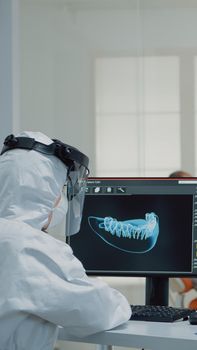 Orthodontists analyzing virtual teeth animation at oral clinic