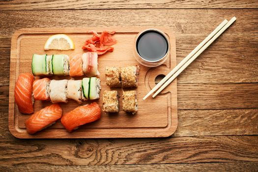 wooden board sushi rolls japanese cuisine sea food. High quality photo