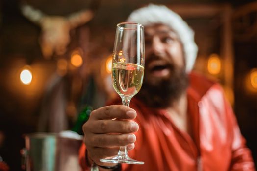 Happy new year. Time to drink. Manly brutal santa leather jacket. Brutal santa claus. Man bearded hipster santa with red hat celebrate with champagne drink. Christmas holiday. Lonely on christmas eve